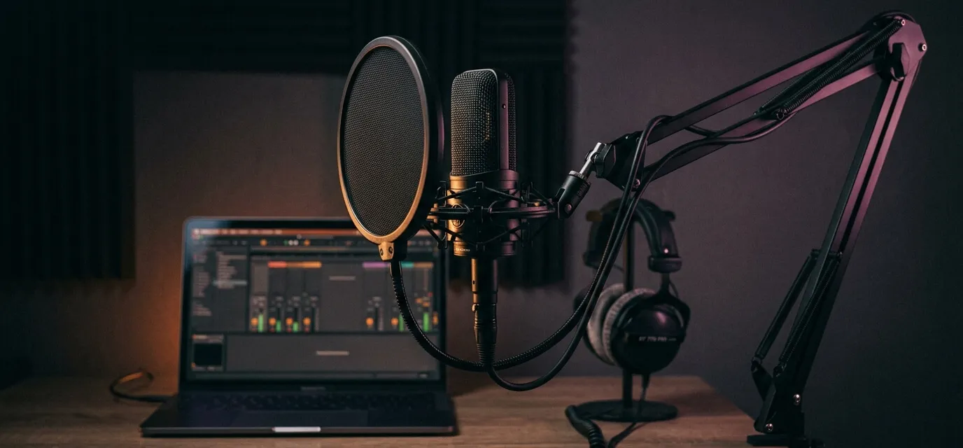 Home studio setup with a condenser microphone, pop filter, and DAW ready to record vocals